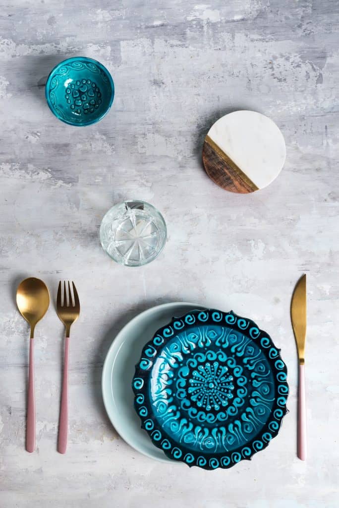 Flat lay of ceramic plate and cutlery utensils on grey background. Empty plate. ,food concept