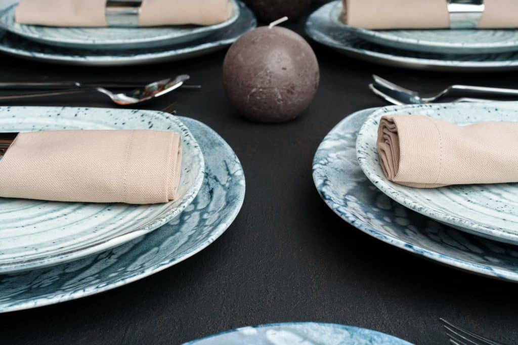 Table setting. Plates with abstract pattern on black table